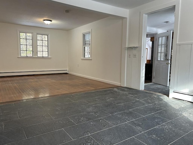 empty room featuring a baseboard heating unit