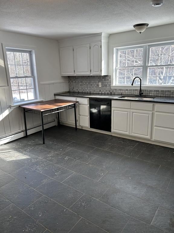 kitchen with black dishwasher, white cabinetry, and sink