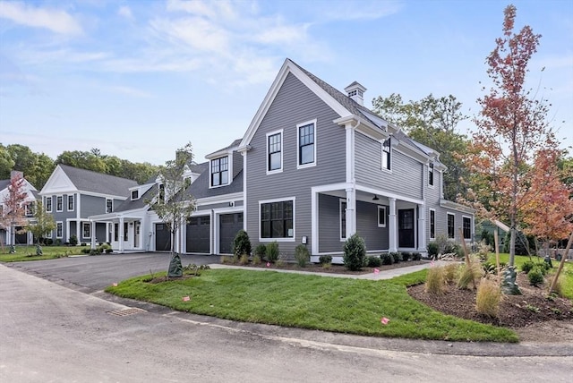 view of front of house featuring a front yard and a garage