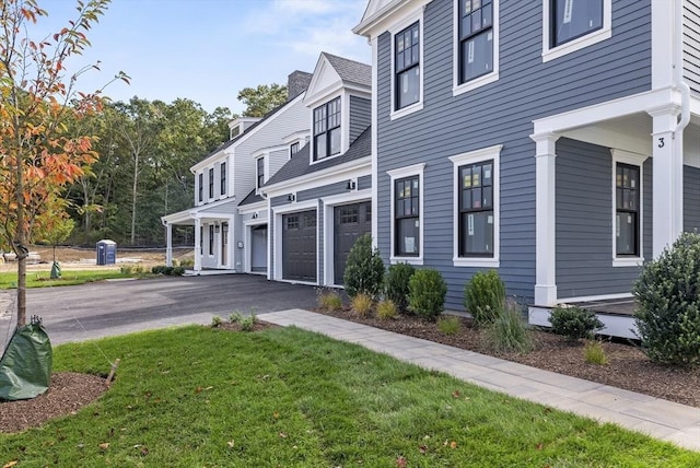 view of front of property with a front lawn and a garage