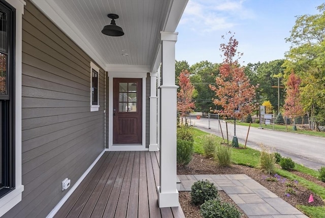 view of exterior entry featuring covered porch