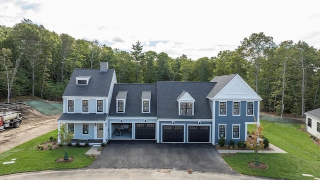 view of front of property with a porch, a front yard, and a garage