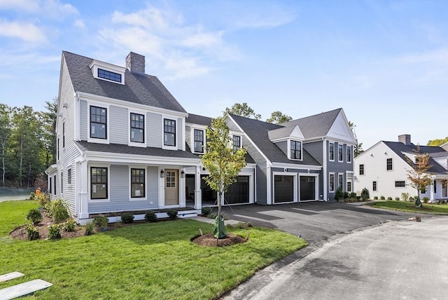 view of front of house featuring a front yard and a garage