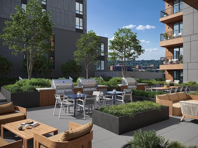 view of patio / terrace with exterior kitchen, an outdoor hangout area, and grilling area