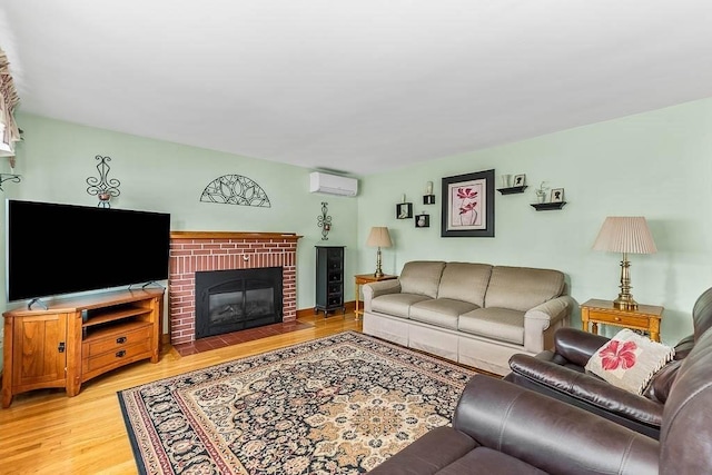 23 Willard St, Dedham, MA 02026 - living area featuring a wall unit AC, light wood-style flooring, and a brick fireplace