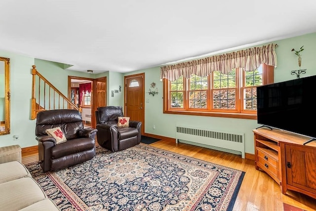 23 Willard St, Dedham, MA 02026 - living area featuring radiator, light wood-type flooring, and stairs