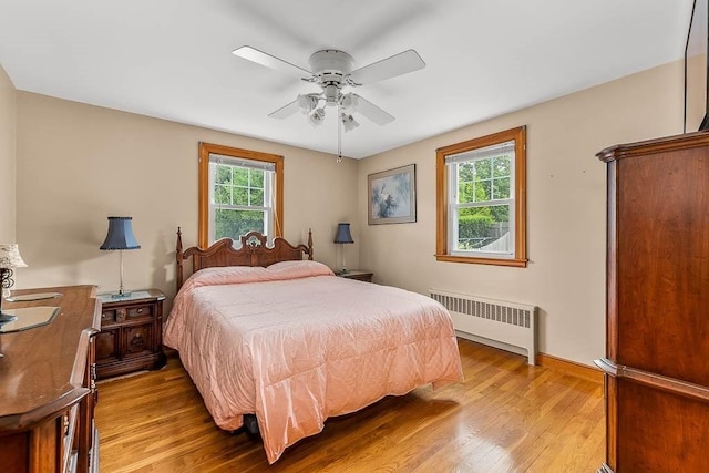 23 Willard St, Dedham, MA 02026 - bedroom with radiator, light wood-style flooring, and a ceiling fan