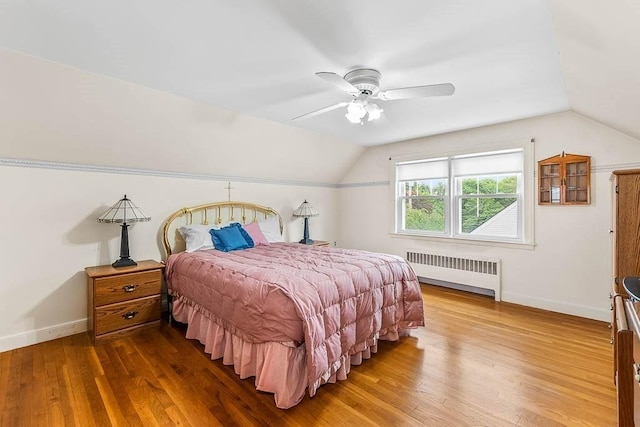 23 Willard St, Dedham, MA 02026 - bedroom with radiator heating unit, vaulted ceiling, wood finished floors, and ceiling fan