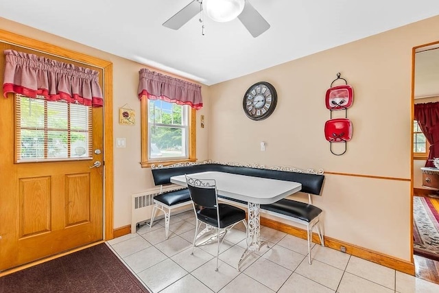 23 Willard St, Dedham, MA 02026 - dining area with radiator, ceiling fan, and light tile patterned flooring