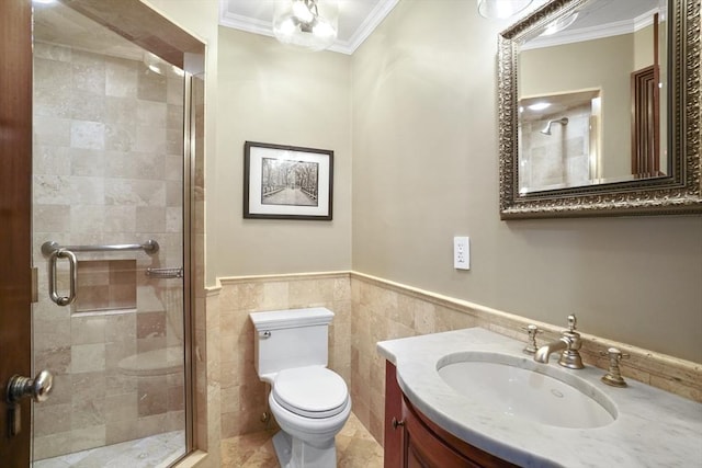 bathroom featuring a stall shower, toilet, crown molding, vanity, and tile walls