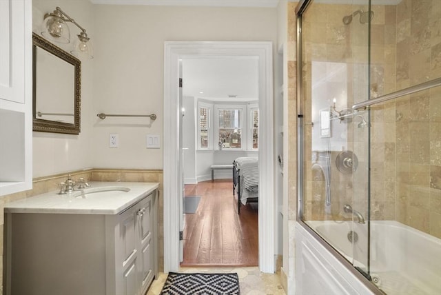 full bath featuring vanity, ensuite bathroom, and bath / shower combo with glass door