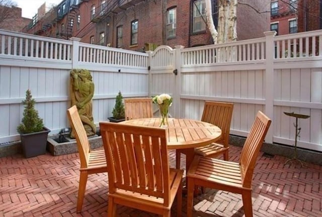 view of patio featuring outdoor dining area and a fenced backyard