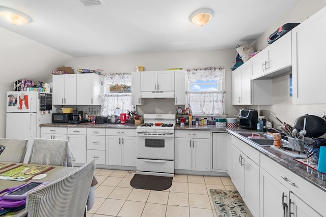 kitchen with white cabinetry, white appliances, sink, and light tile patterned floors