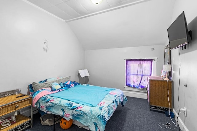 bedroom featuring lofted ceiling and dark colored carpet