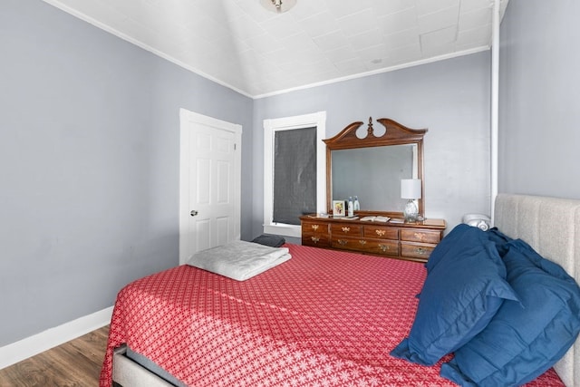 bedroom featuring hardwood / wood-style flooring and crown molding