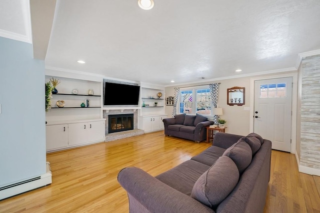 living room with crown molding, a baseboard radiator, built in features, and light wood-type flooring