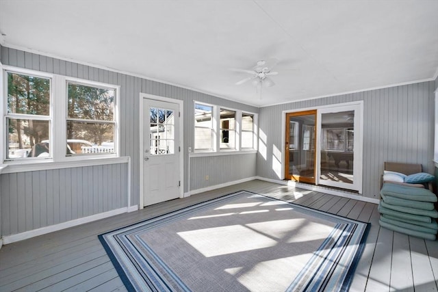 unfurnished sunroom featuring ceiling fan