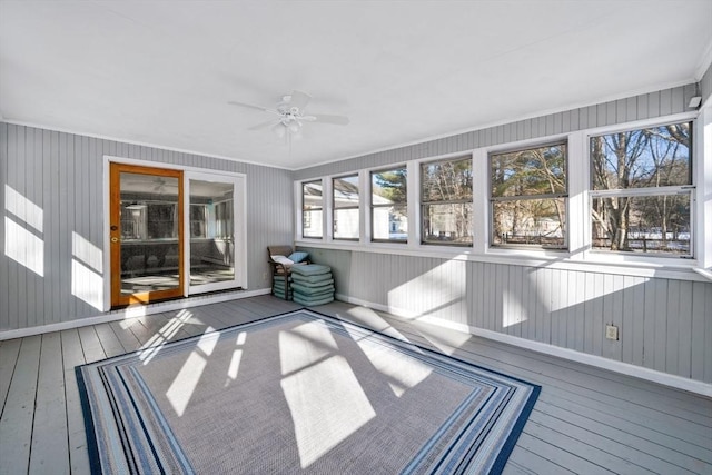 unfurnished sunroom with ceiling fan