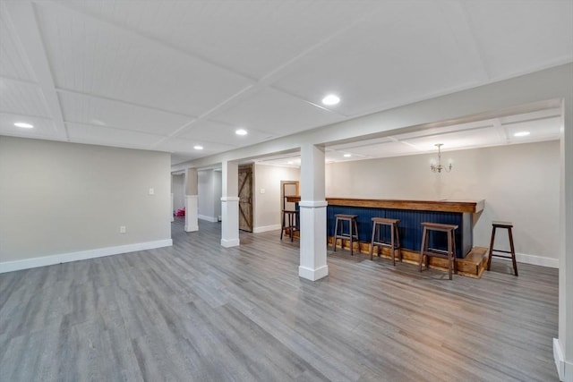 basement featuring hardwood / wood-style flooring and bar area