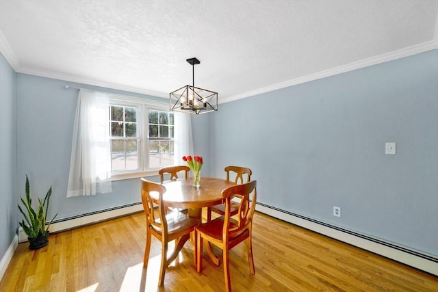 dining room featuring a baseboard radiator, crown molding, and light hardwood / wood-style floors