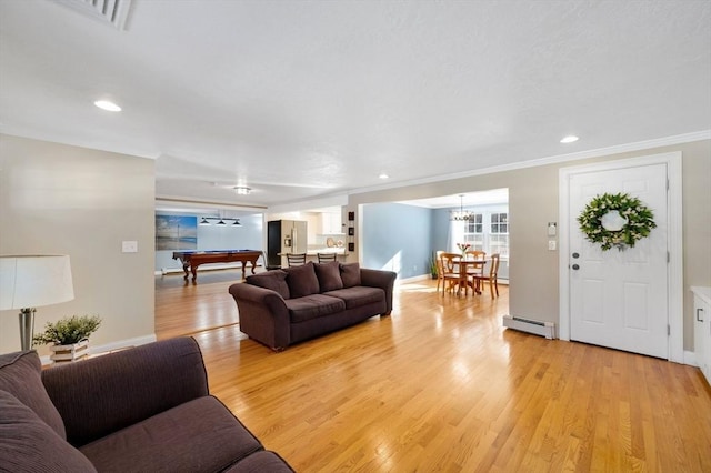 living room featuring a baseboard radiator, ornamental molding, billiards, and light wood-type flooring