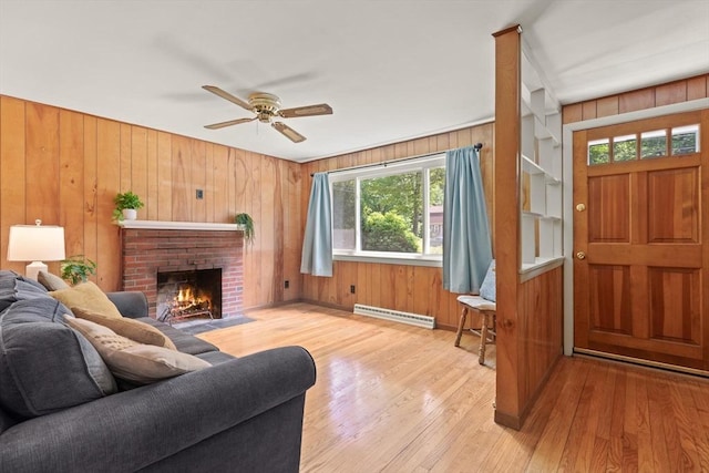 133 Allen Rd, Easton, MA 02356 - living area featuring a ceiling fan, wood walls, a baseboard radiator, wood finished floors, and a fireplace