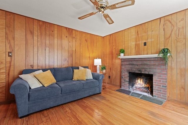 133 Allen Rd, Easton, MA 02356 - living room featuring wood finished floors, a fireplace, a ceiling fan, and wooden walls