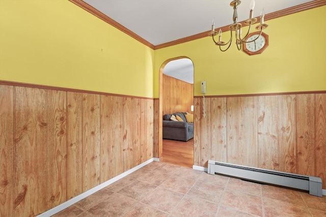 133 Allen Rd, Easton, MA 02356 - spare room with baseboard heating, wainscoting, crown molding, arched walkways, and wood walls