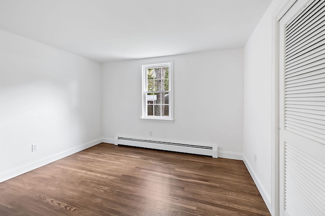 unfurnished room featuring a baseboard radiator and dark hardwood / wood-style flooring