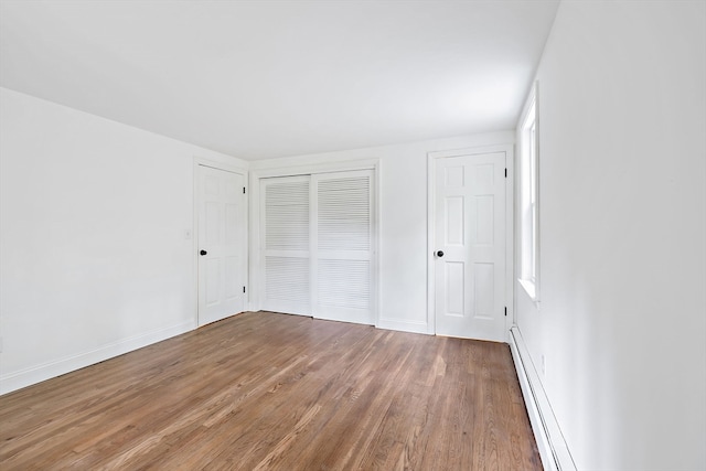 unfurnished bedroom featuring hardwood / wood-style flooring