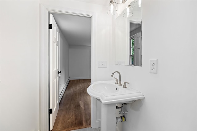 bathroom with a baseboard radiator and hardwood / wood-style floors