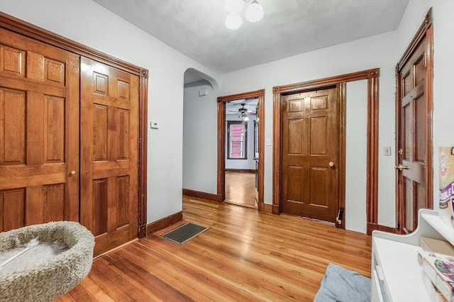 71 Draper St, Boston, MA 02122 - foyer entrance with arched walkways, baseboards, and light wood finished floors