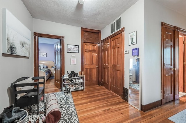 71 Draper St, Boston, MA 02122 - hall with light wood-type flooring and a textured ceiling