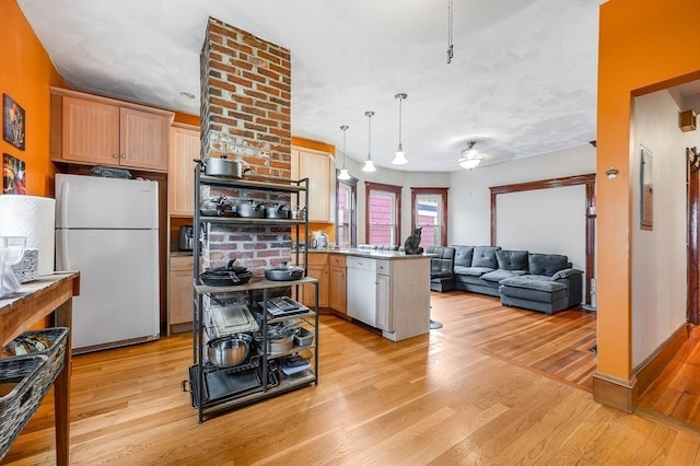 71 Draper St, Boston, MA 02122 - kitchen featuring white appliances, a peninsula, open floor plan, light wood-style flooring, and decorative light fixtures
