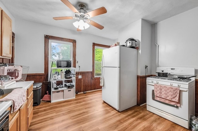 71 Draper St, Boston, MA 02122 - kitchen featuring white appliances, a wainscoted wall, light wood finished floors, a ceiling fan, and wood walls