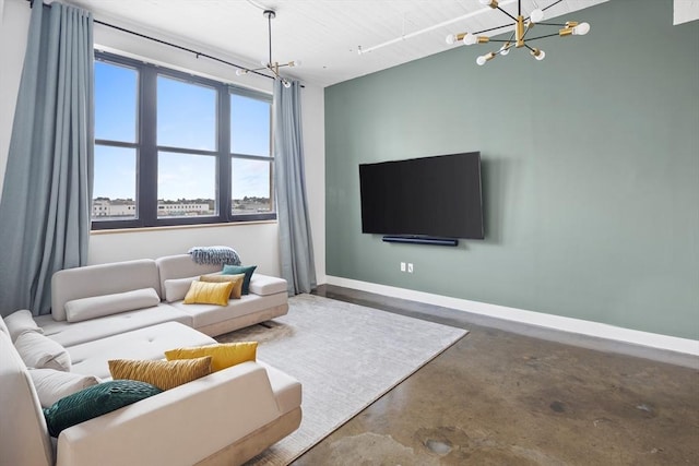 437 D St Unit 3D, Boston, MA 02210 - living room with a chandelier, concrete flooring, and baseboards
