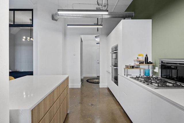 437 D St Unit 3D, Boston, MA 02210 - kitchen with stainless steel appliances, finished concrete floors, modern cabinets, baseboards, and a high ceiling