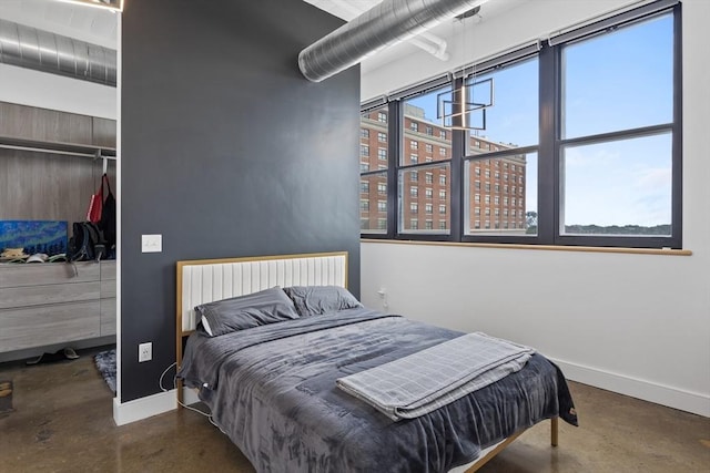 437 D St Unit 3D, Boston, MA 02210 - bedroom featuring concrete flooring, baseboards, and a closet