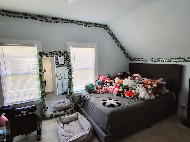 carpeted bedroom featuring vaulted ceiling