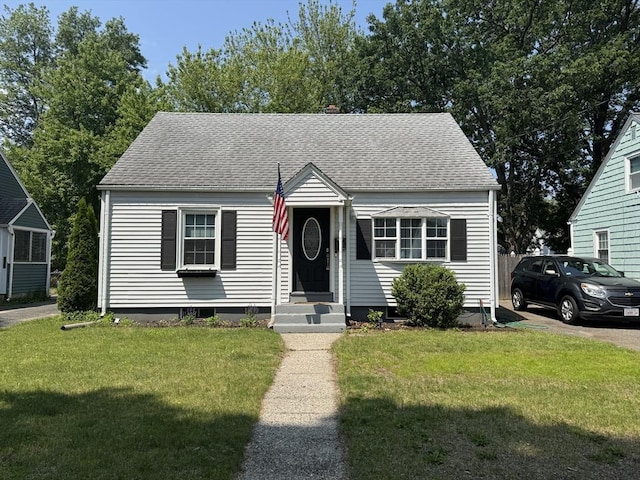 156 Powell, Springfield, MA 01118 - view of front of house with a shingled roof and a front lawn