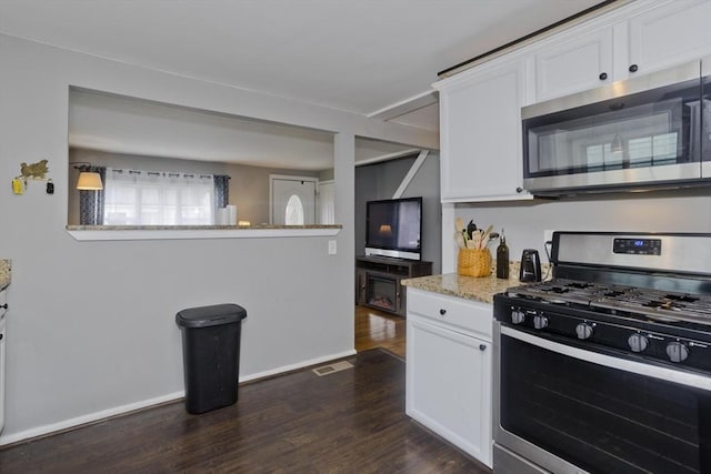 156 Powell, Springfield, MA 01118 - kitchen featuring stainless steel appliances, dark wood-style floors, white cabinets, and light stone counters