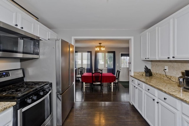 156 Powell, Springfield, MA 01118 - kitchen with stainless steel appliances, white cabinets, dark wood finished floors, a chandelier, and light stone countertops