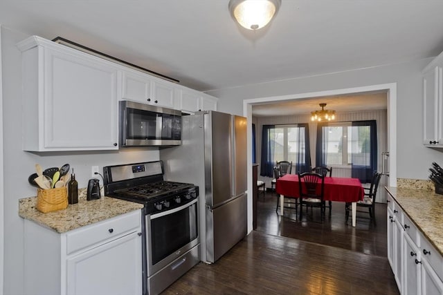 156 Powell, Springfield, MA 01118 - kitchen featuring appliances with stainless steel finishes, white cabinets, dark wood-style floors, and light stone counters