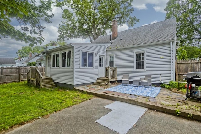156 Powell, Springfield, MA 01118 - back of property with a chimney, a shingled roof, and a patio