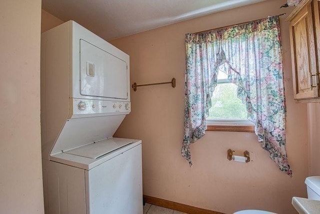 clothes washing area with stacked washer / drying machine
