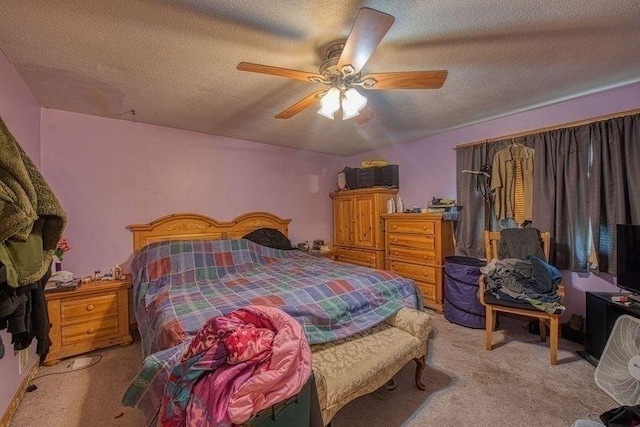 bedroom with light colored carpet, a textured ceiling, and a ceiling fan