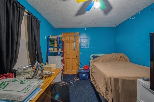 carpeted bedroom featuring a textured ceiling and a ceiling fan