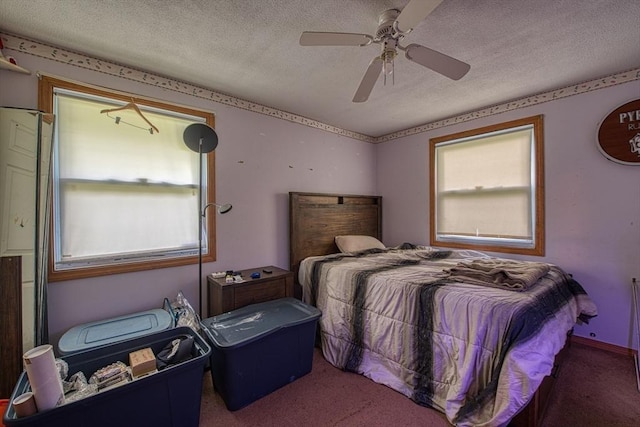 carpeted bedroom featuring a textured ceiling, multiple windows, and ceiling fan