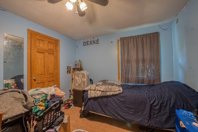bedroom with carpet, a textured ceiling, and a ceiling fan