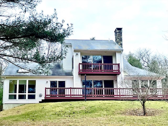 back of property with a lawn and a wooden deck